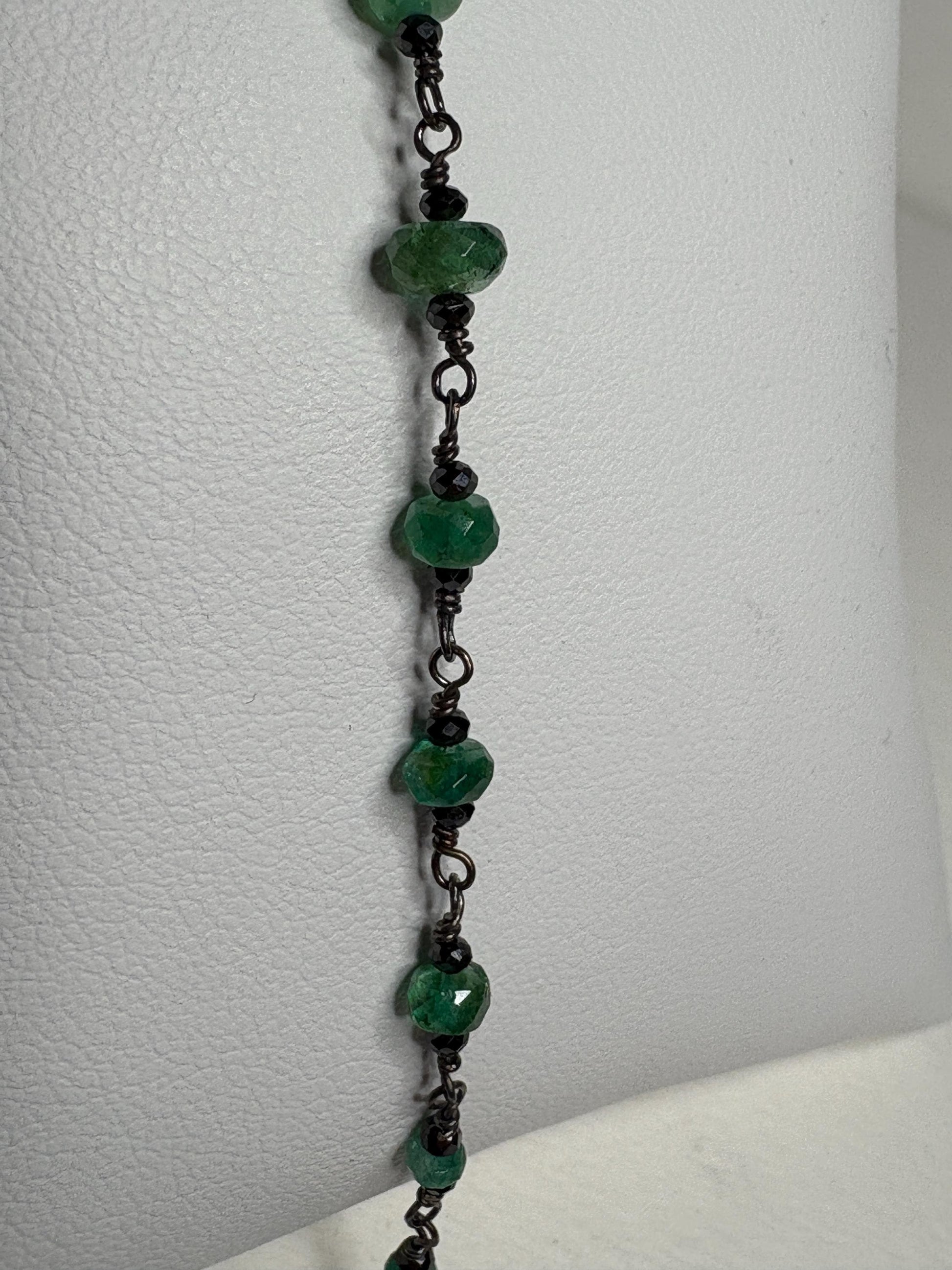 Oxidized sterling silver bracelet with faceted emeralds and black diamond beads.