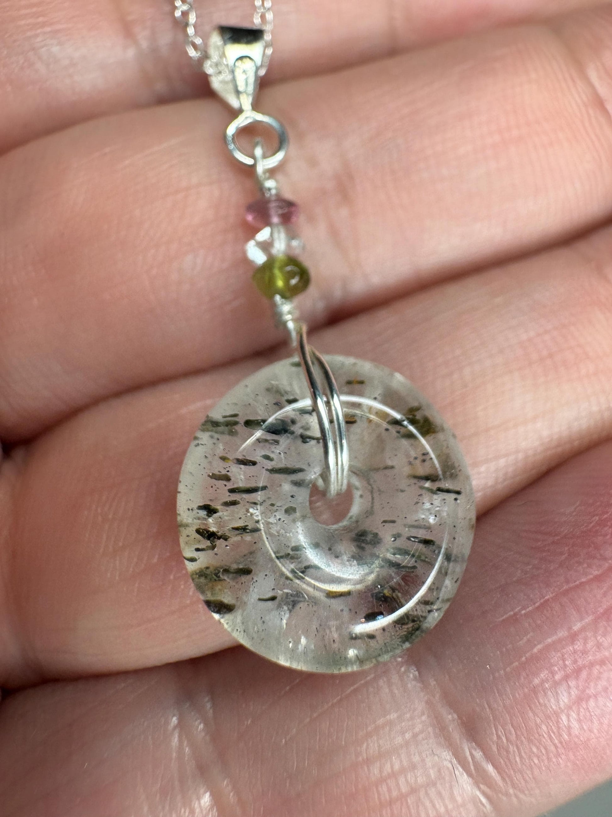 Sterling silver necklace with a tourmalated quartz donut pendant and tourmaline beads.