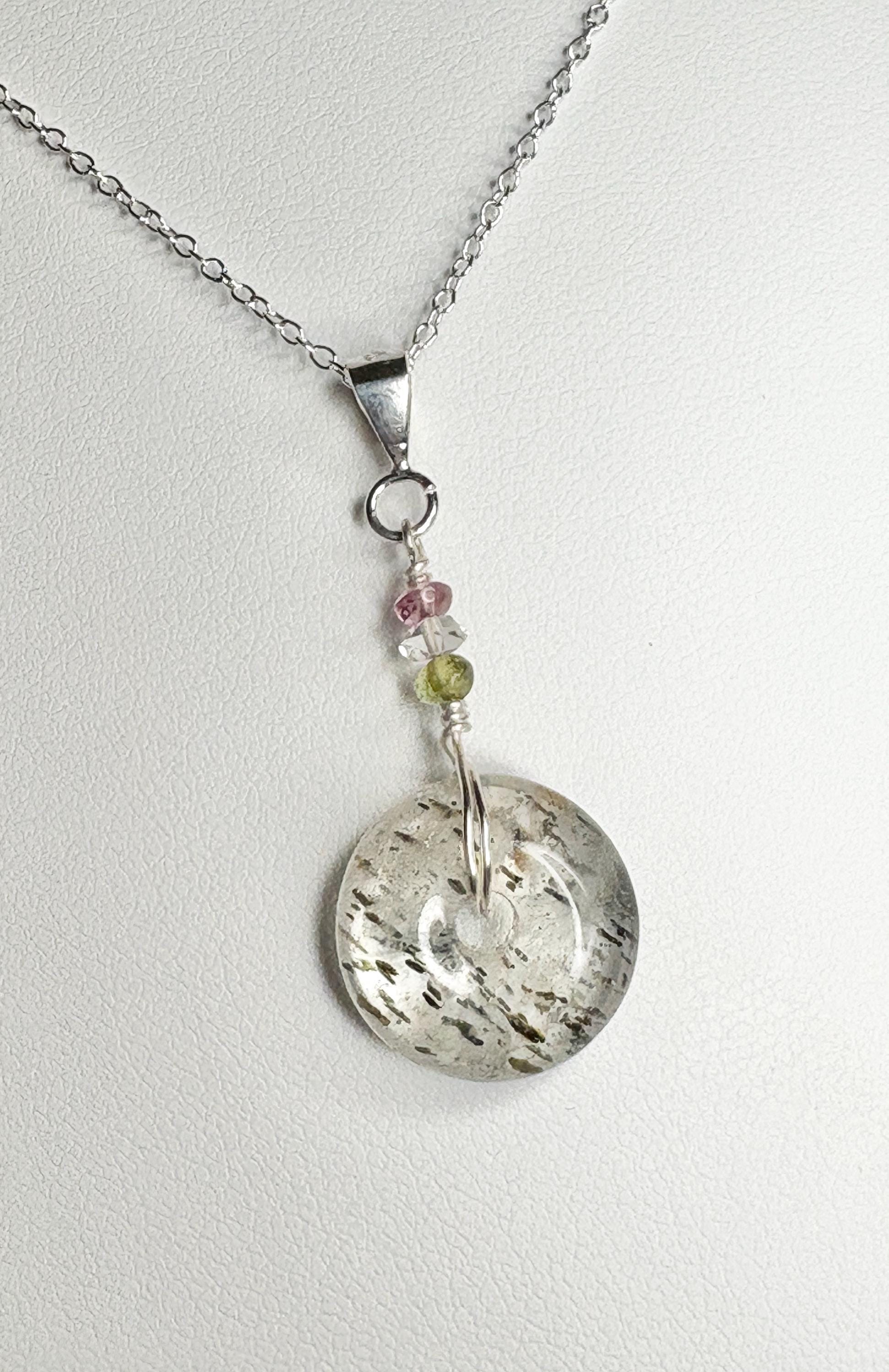 Sterling silver necklace with a tourmalated quartz donut pendant and tourmaline beads.