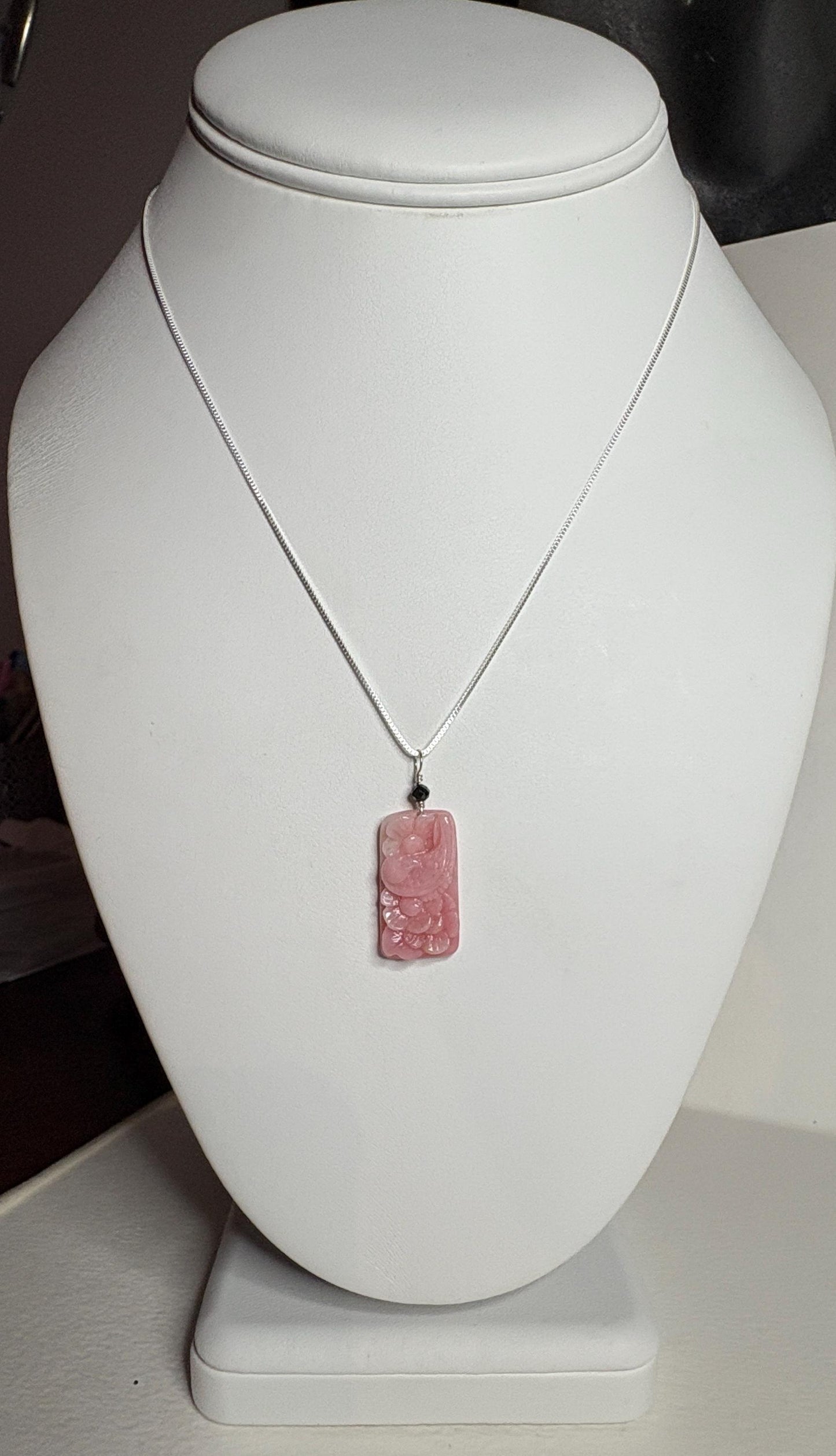 Peruvian pink opal pendant with carved dove and blossoms on a sterling silver chain.