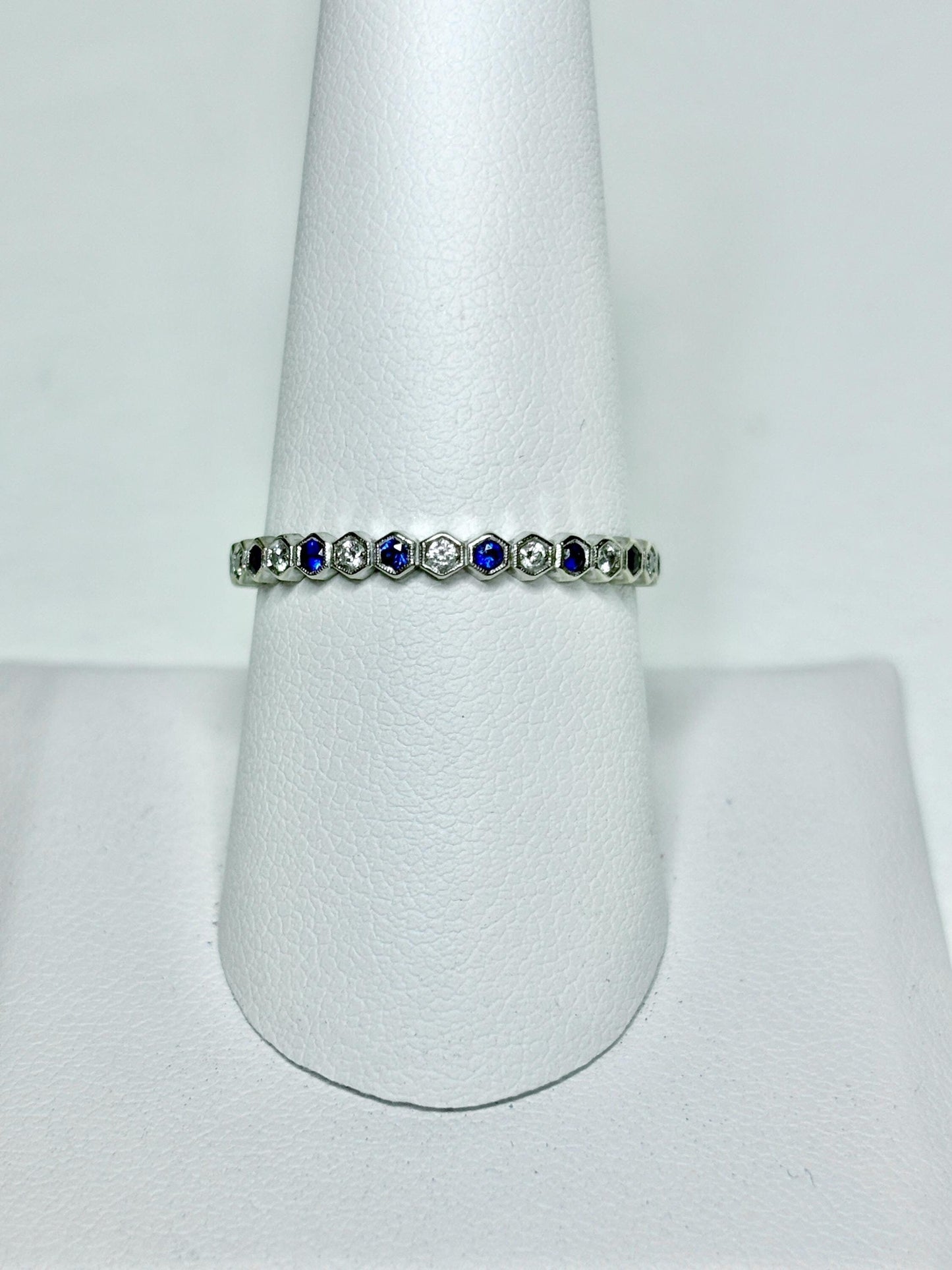 A 14k white gold ring with alternating blue sapphires and diamonds in a honeycomb hexagon pattern.
