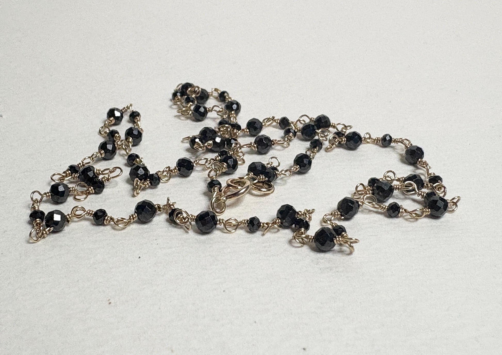 14k gold necklace with 2-3mm natural black diamond beads.