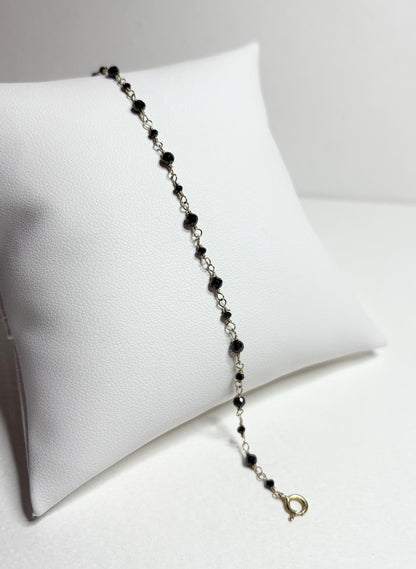 A 7-inch bracelet with black diamond beads and a 14k gold clasp.