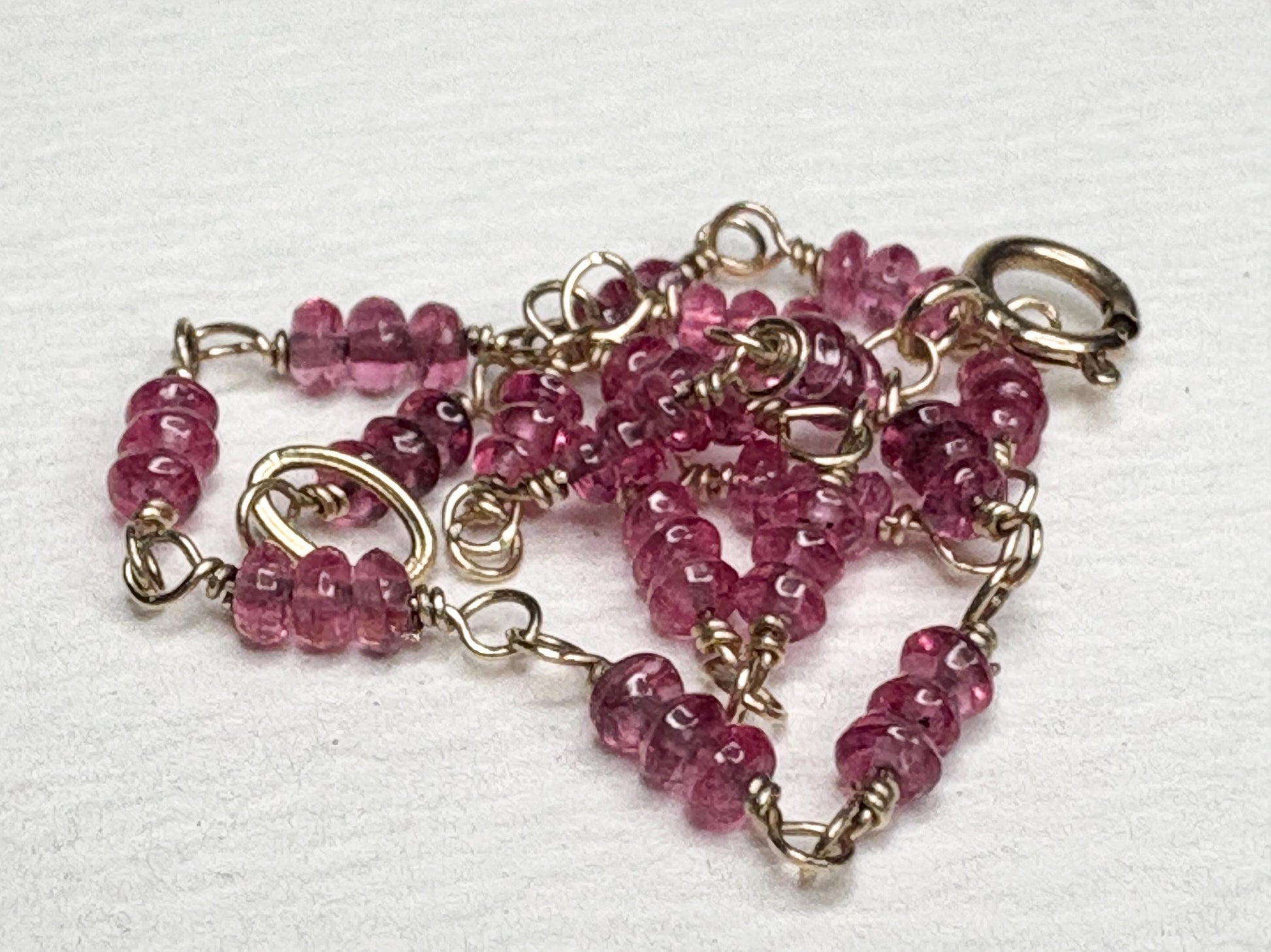 A 7-inch bracelet with smooth, hot pink spinel beads and 14k gold findings.