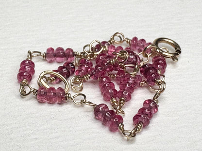 A 7-inch bracelet with smooth, hot pink spinel beads and 14k gold findings.