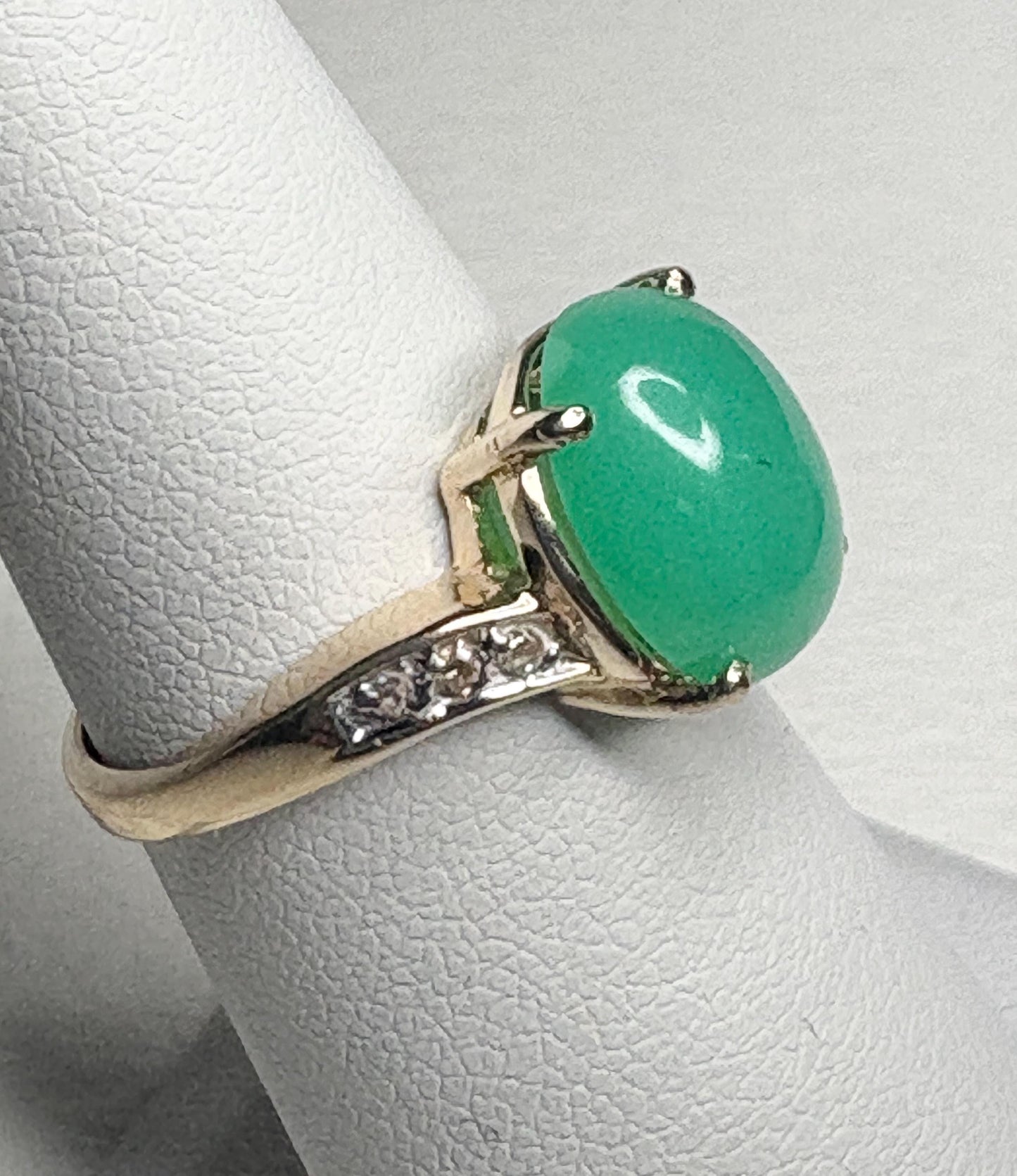 A 14k gold ring with an oval Australian chrysoprase and diamond accents.