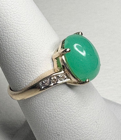 A 14k gold ring with an oval Australian chrysoprase and diamond accents.
