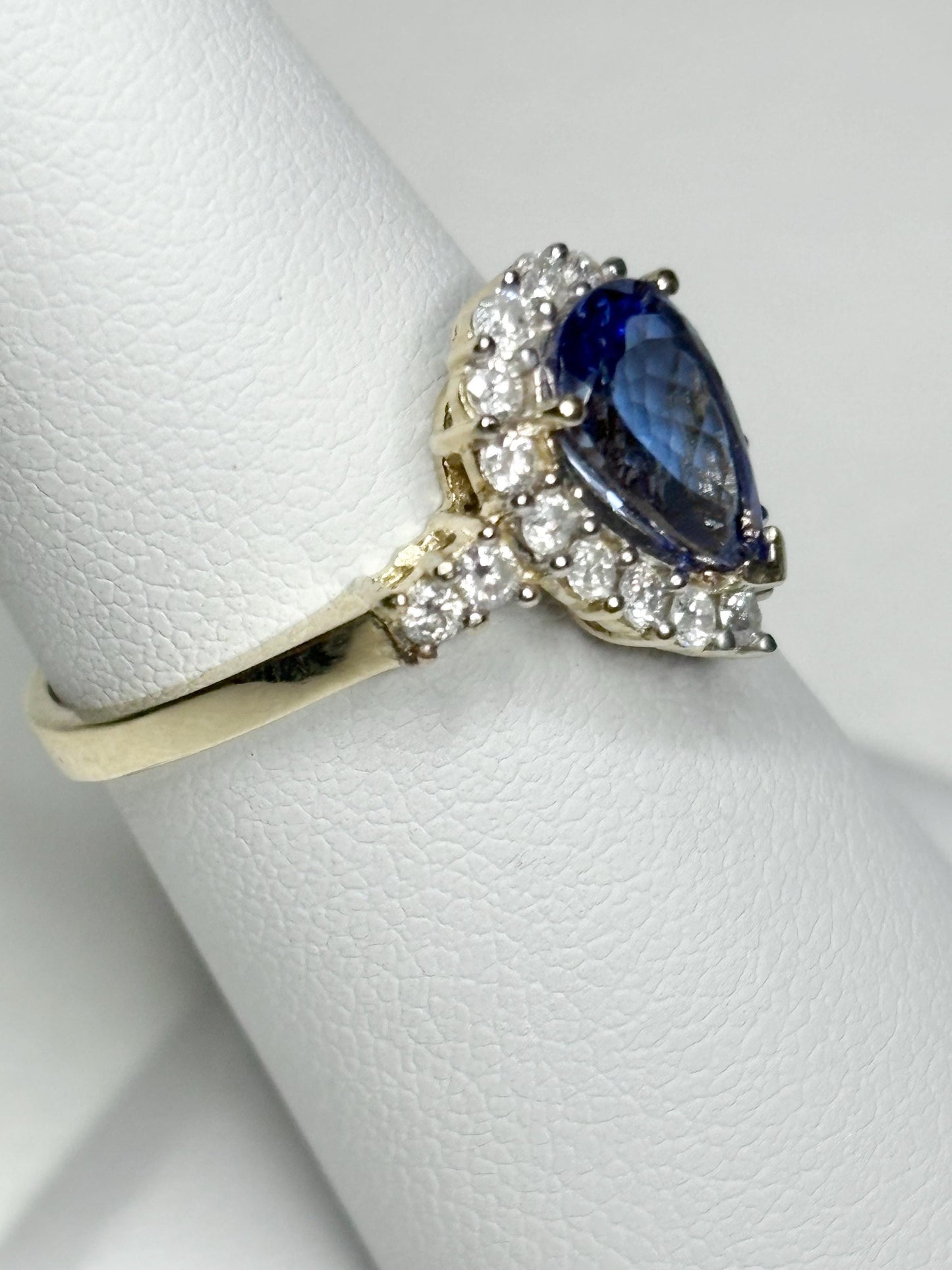 14k gold ring with pear-shaped tanzanite and diamond halo.