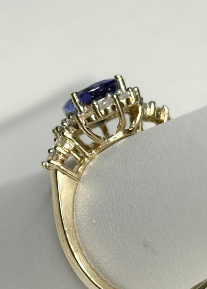 Natural pear tanzanite and diamond halo ring in solid 14k gold.
