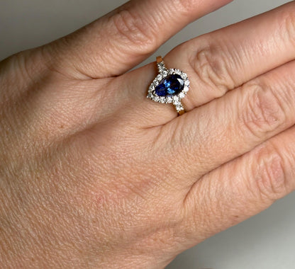 Pear tanzanite and diamond halo ring in 14k gold.