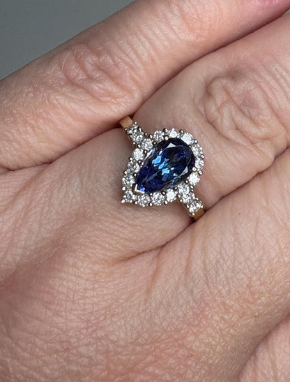 Pear tanzanite and diamond halo ring in 14k gold.