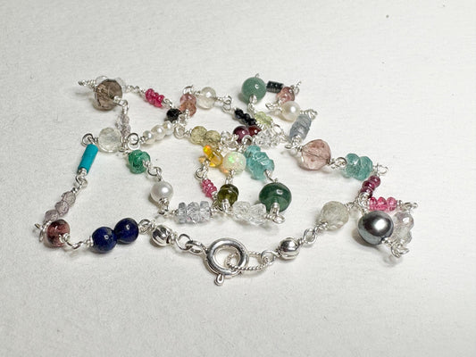 Sterling silver necklace with a variety of colorful natural gemstones.