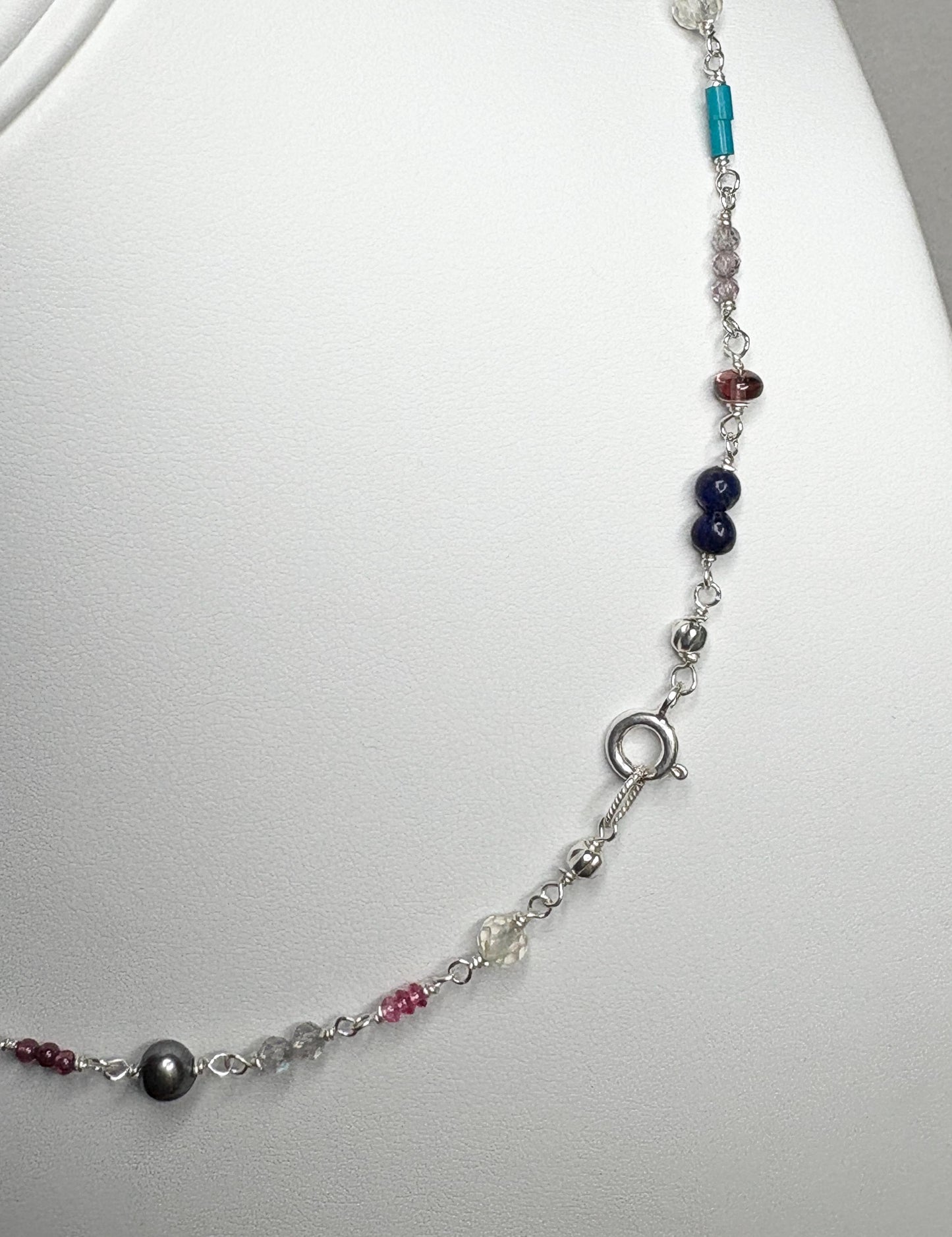Sterling silver necklace with colorful gemstone beads and a black pearl.