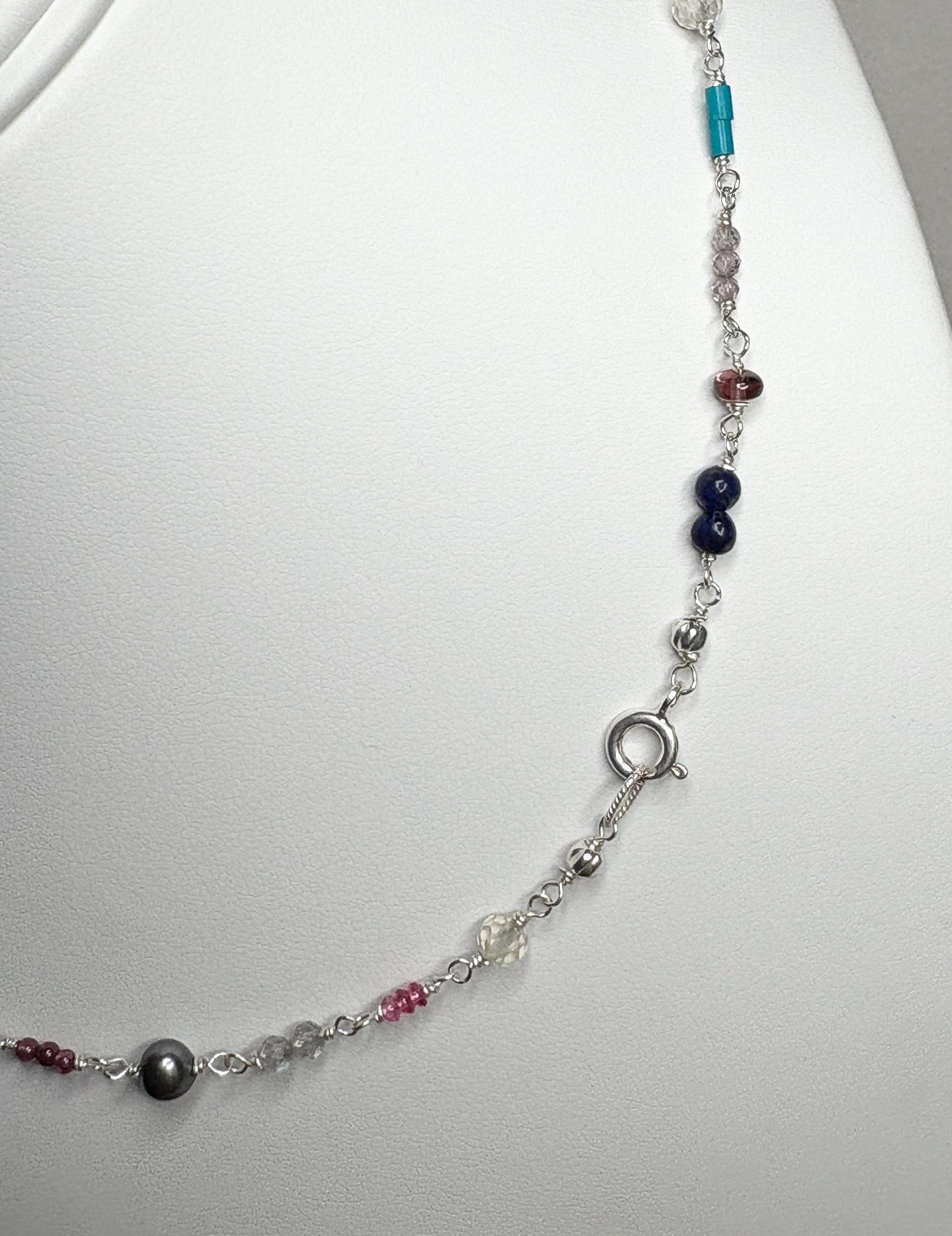 Sterling silver necklace with colorful gemstone beads and a black pearl.