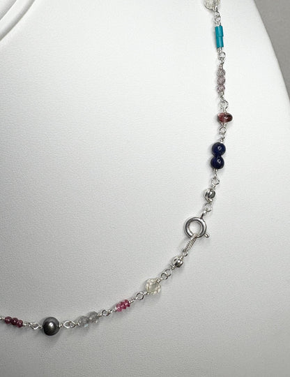 Sterling silver necklace with colorful gemstone beads and a black pearl.