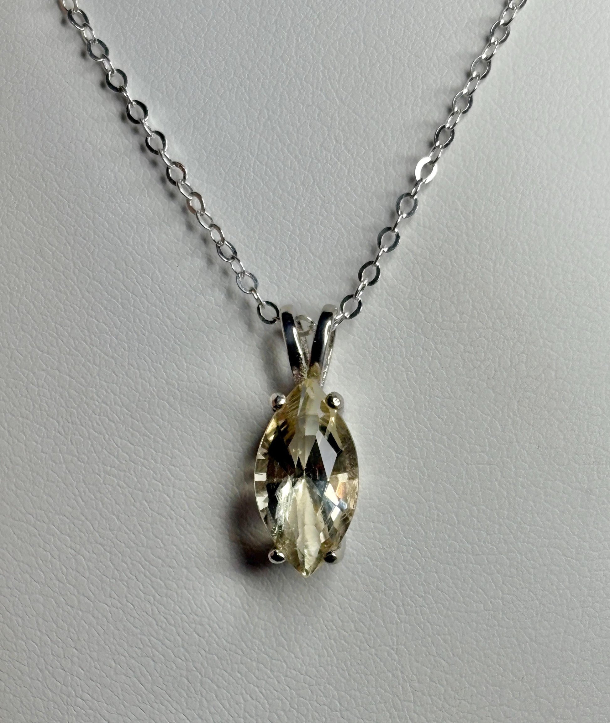 Sterling silver necklace with an 18-inch chain and a marquise-cut Oregon sunstone pendant.