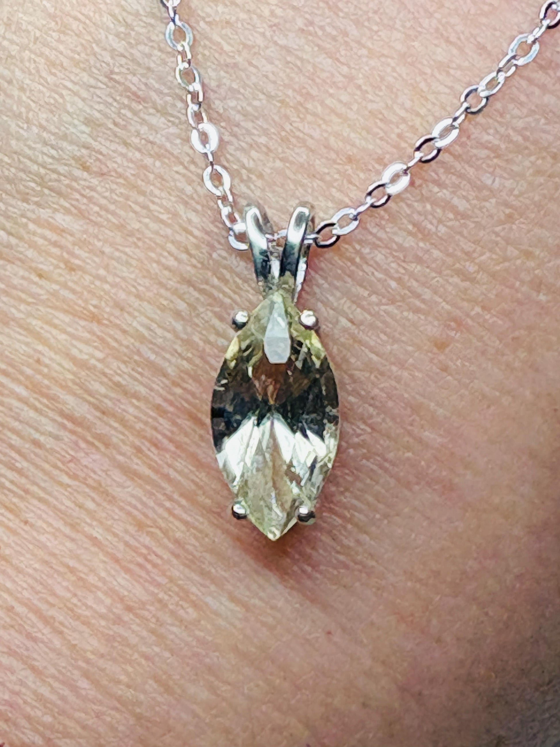 Sterling silver necklace with a marquise-cut Oregon sunstone pendant.