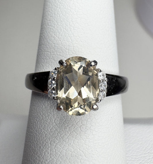 Sterling silver ring with an oval Oregon sunstone and accent crystals.