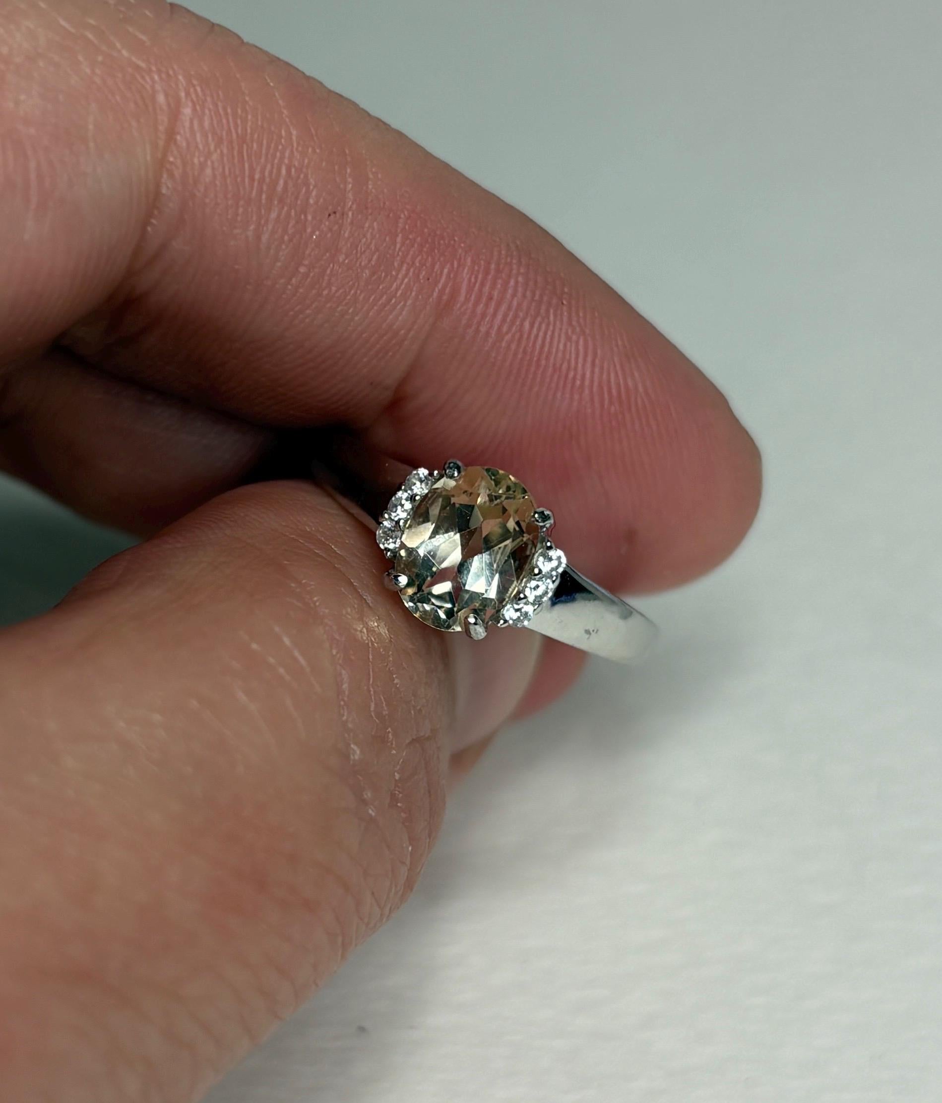 Sterling silver ring with an oval Oregon sunstone and accent crystals.