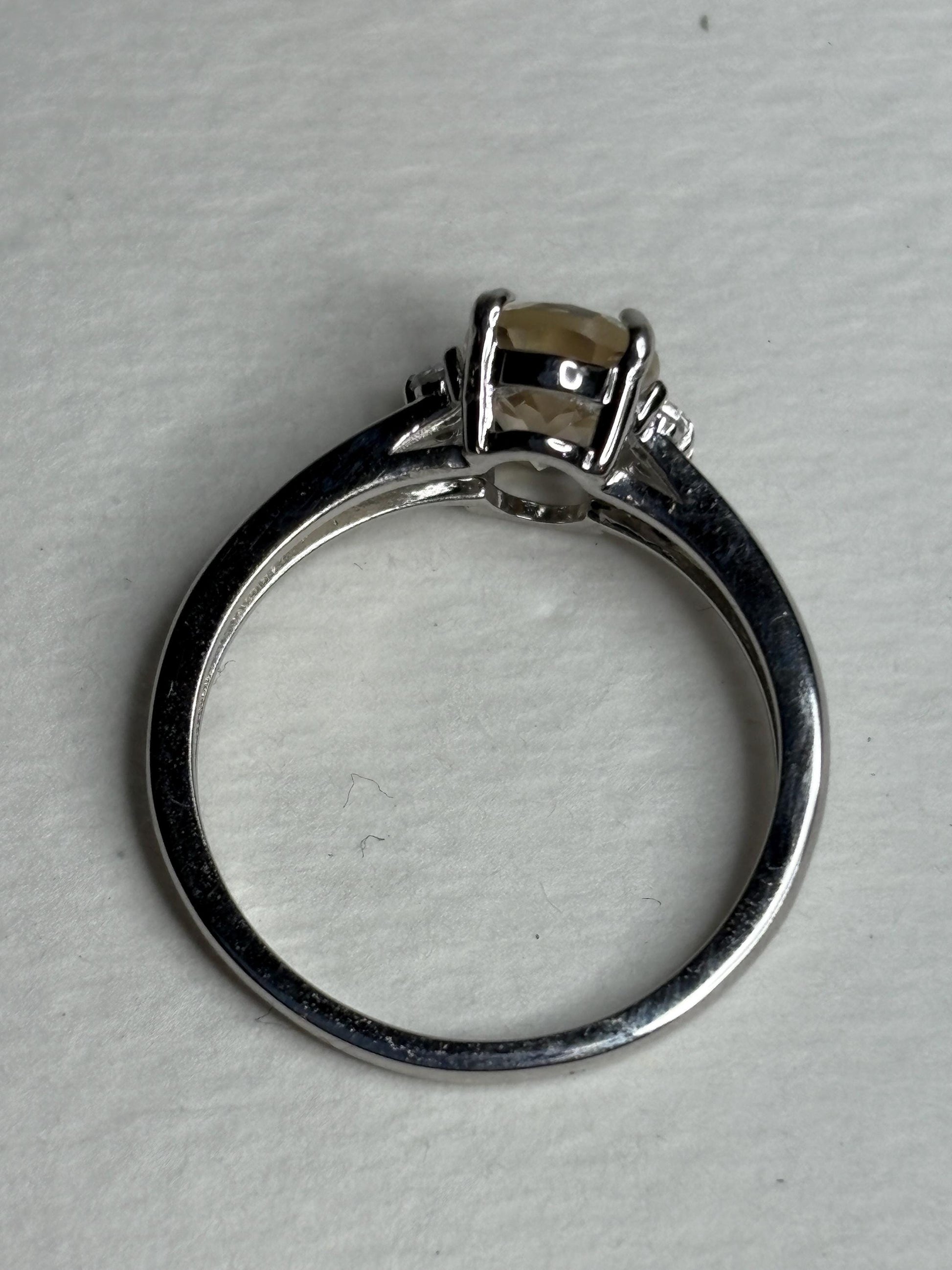 Sterling silver ring with an oval Oregon sunstone and accent crystals.