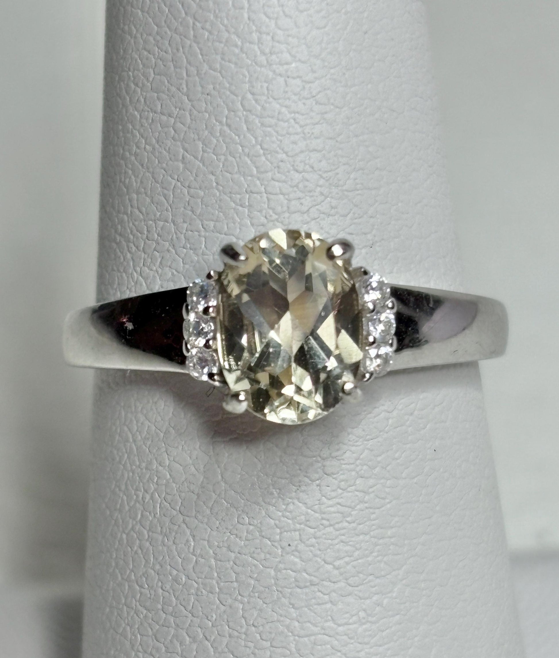 Sterling silver ring with an oval Oregon sunstone and accent crystals.