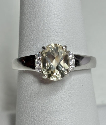 Sterling silver ring with an oval Oregon sunstone and accent crystals.