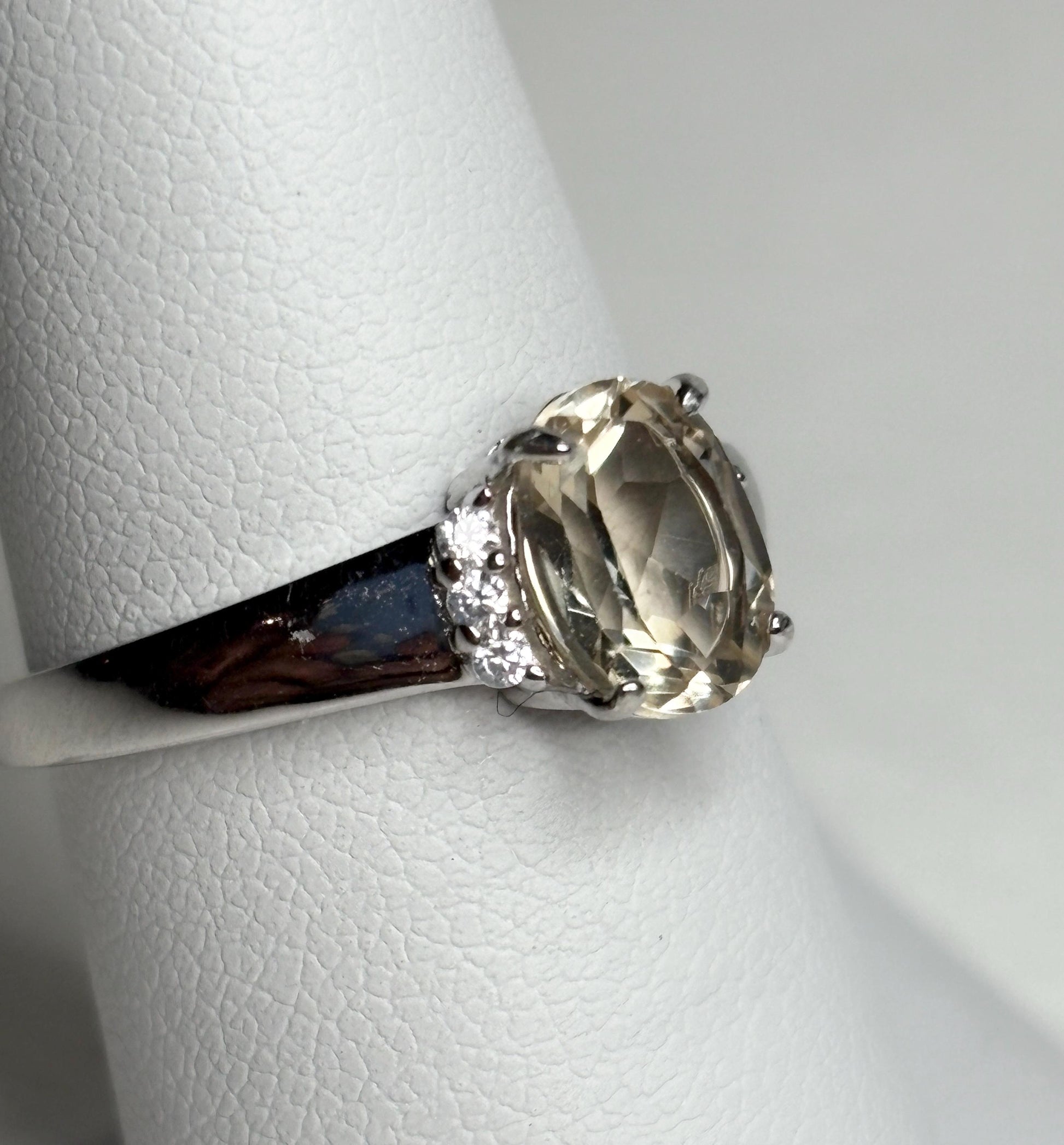 Sterling silver ring with an oval Oregon sunstone and accent crystals.