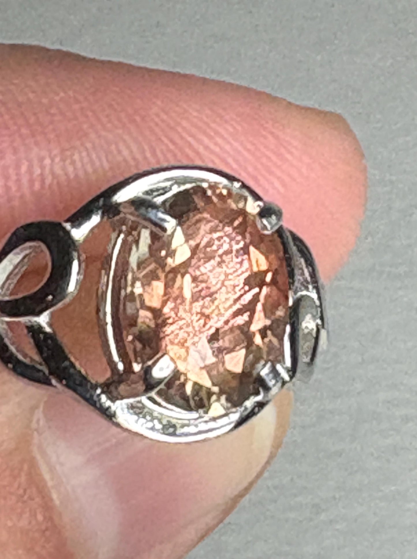 Sterling silver ring with an oval Oregon sunstone featuring shiller.