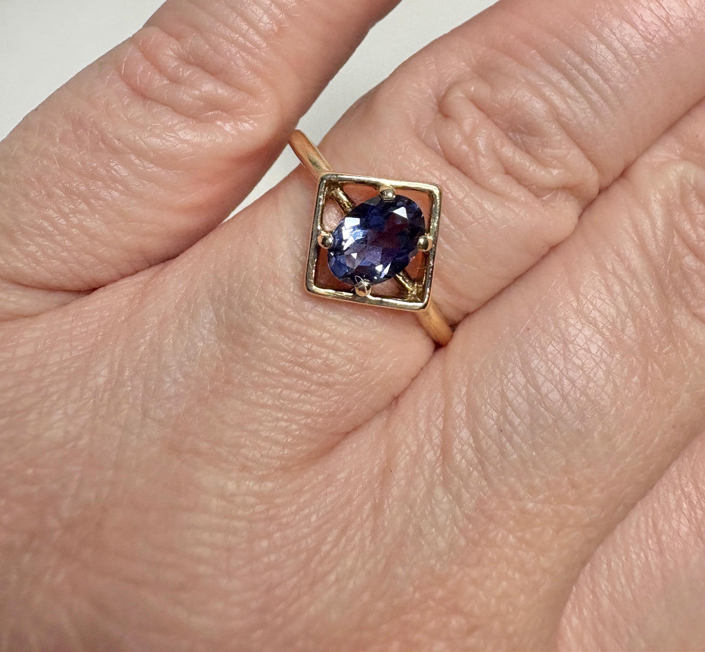 Geometric 10k gold ring with an oval iolite gemstone.
