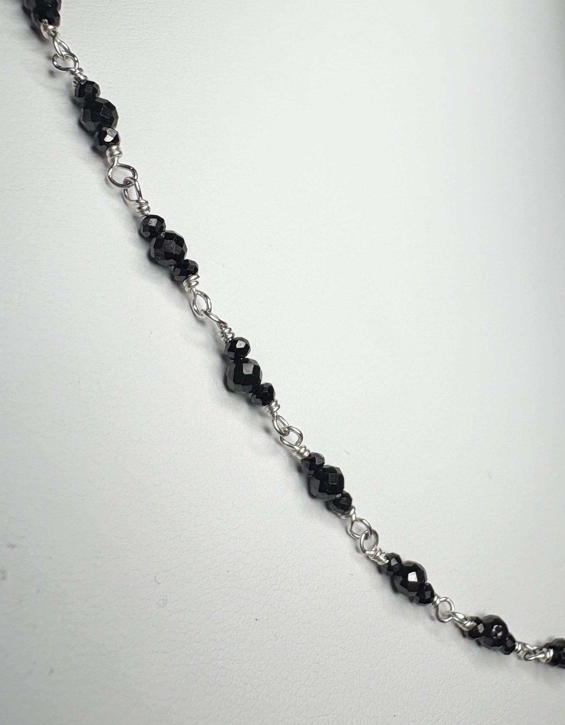 Sterling silver necklace with faceted black diamond beads.