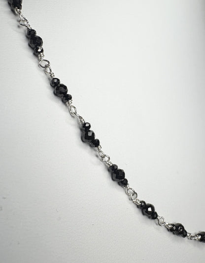 Sterling silver necklace with faceted black diamond beads.