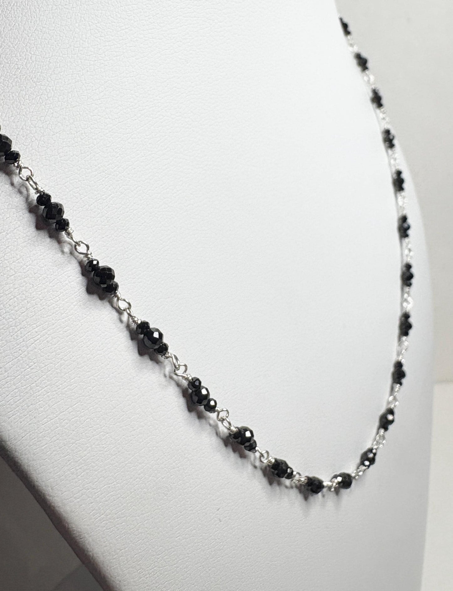 Sterling silver necklace with faceted black diamond beads.