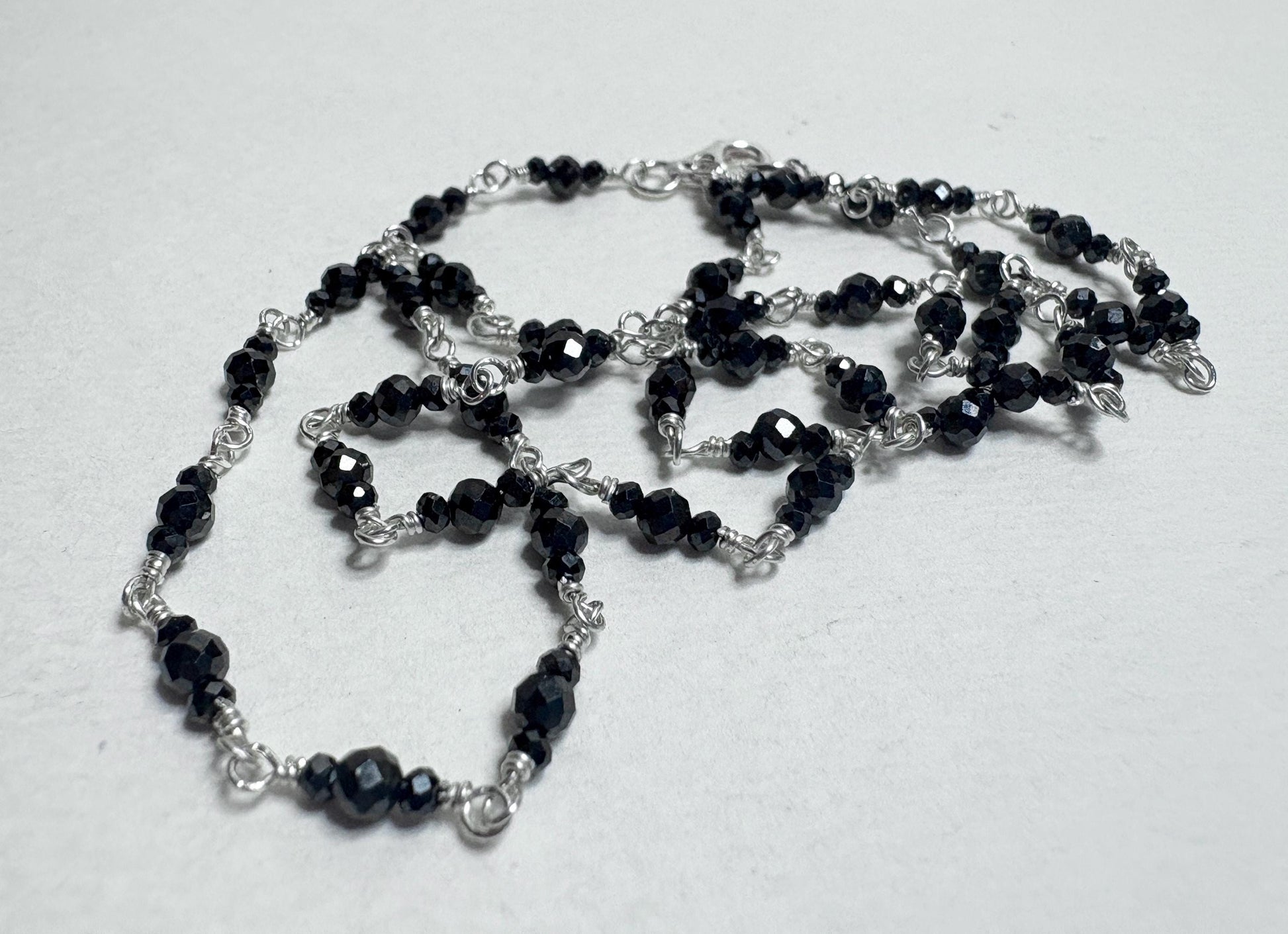 Sterling silver necklace with faceted black diamond beads.
