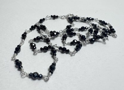 Sterling silver necklace with faceted black diamond beads.
