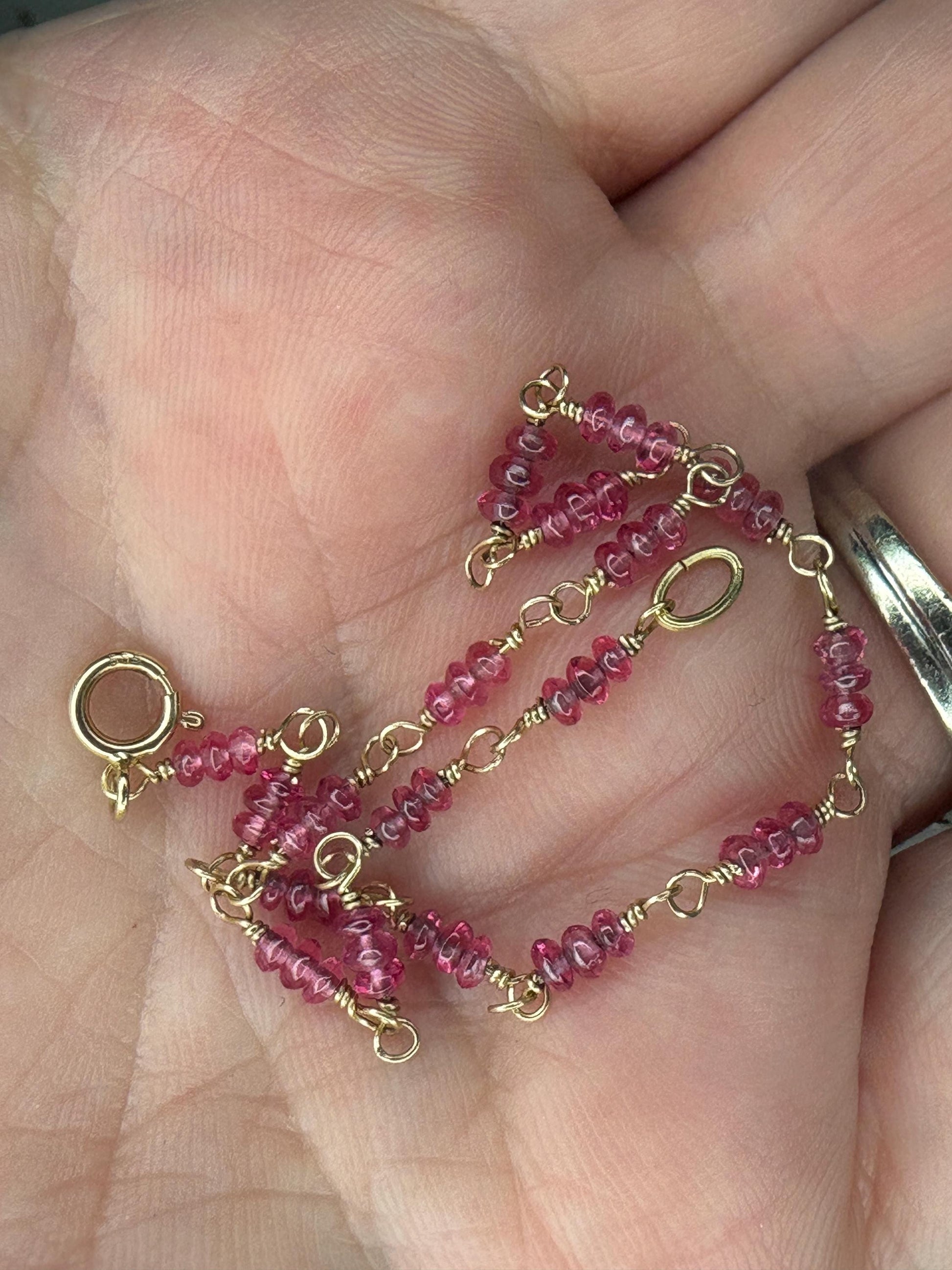 A delicate 14k gold bracelet with small, faceted hot pink spinel beads.