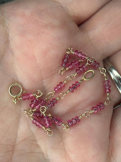 A delicate 14k gold bracelet with small, faceted hot pink spinel beads.