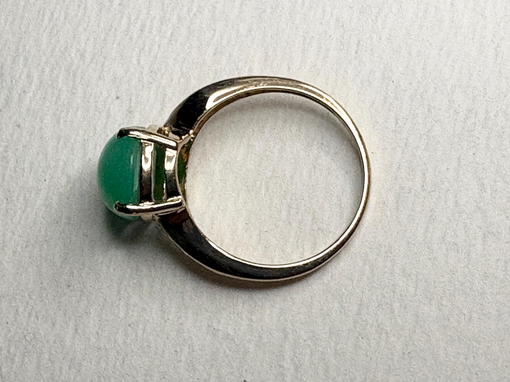 A 14k gold ring with a green chrysoprase stone.