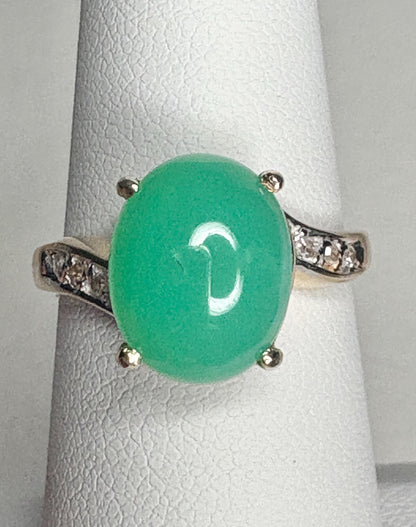A 14k gold ring with a green chrysoprase stone and diamond accents.