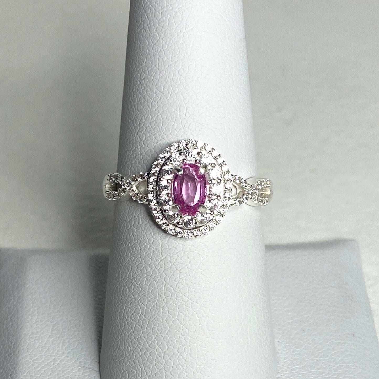 Oval pink sapphire and zircon double halo ring in sterling silver.