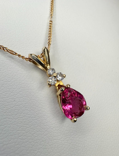 Rubellite tourmaline and diamond pendant on a 14k gold chain.