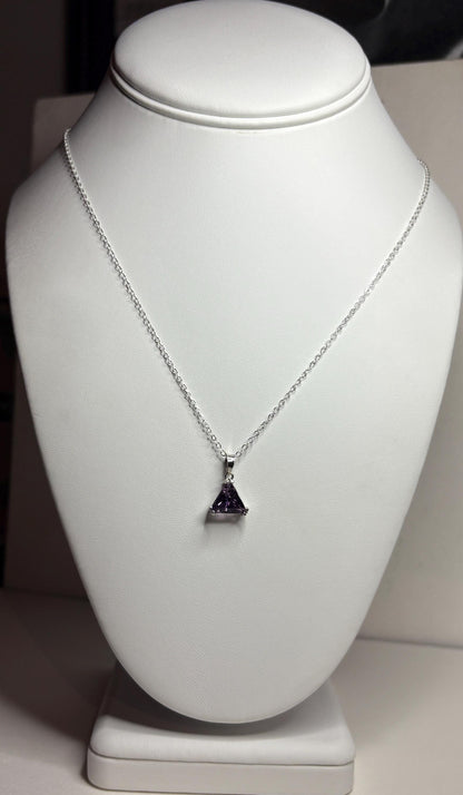 Sterling silver necklace with a triangular amethyst pendant.