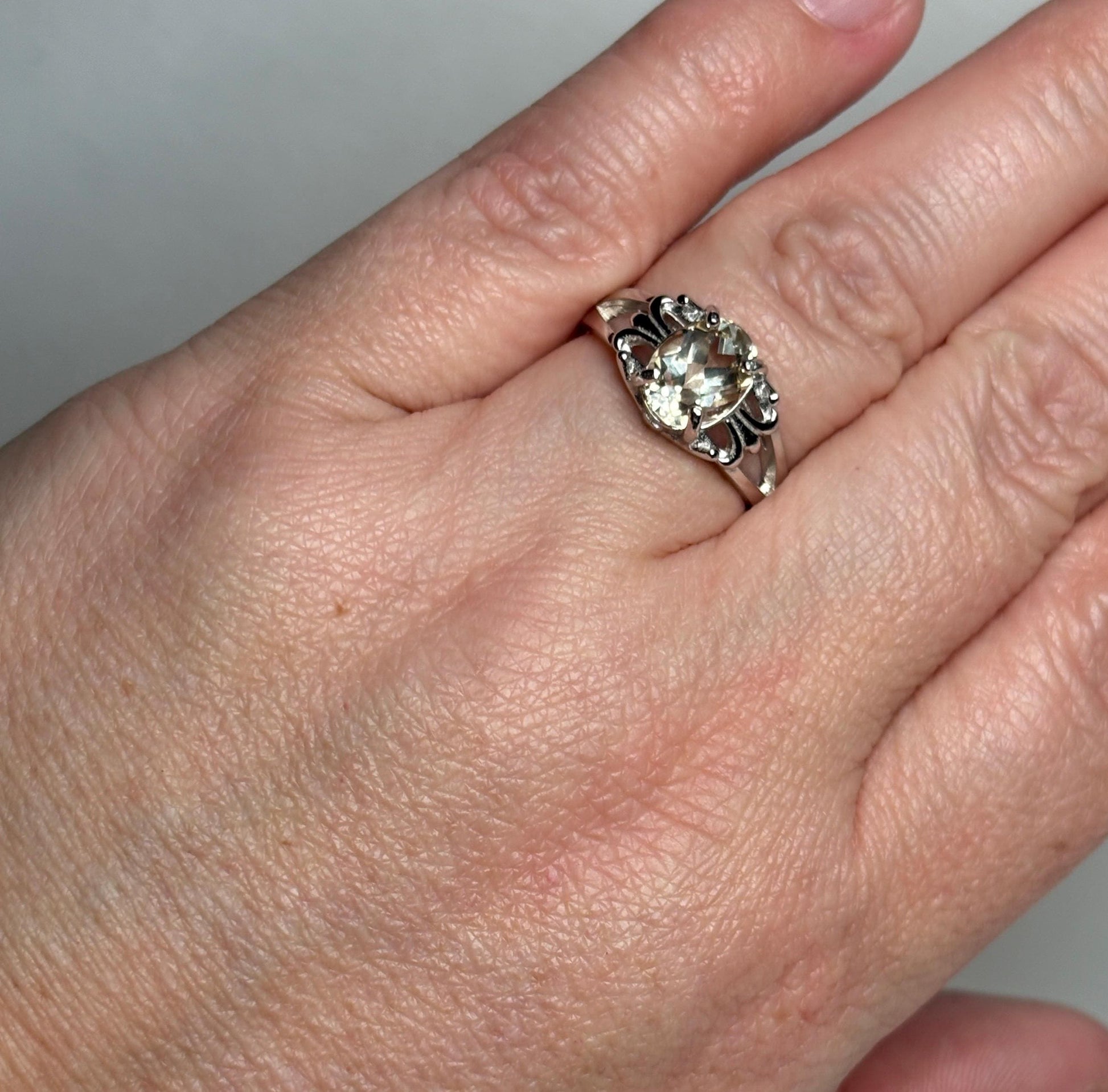 Sterling silver ring with a yellow Oregon sunstone in a fleur de lis design.