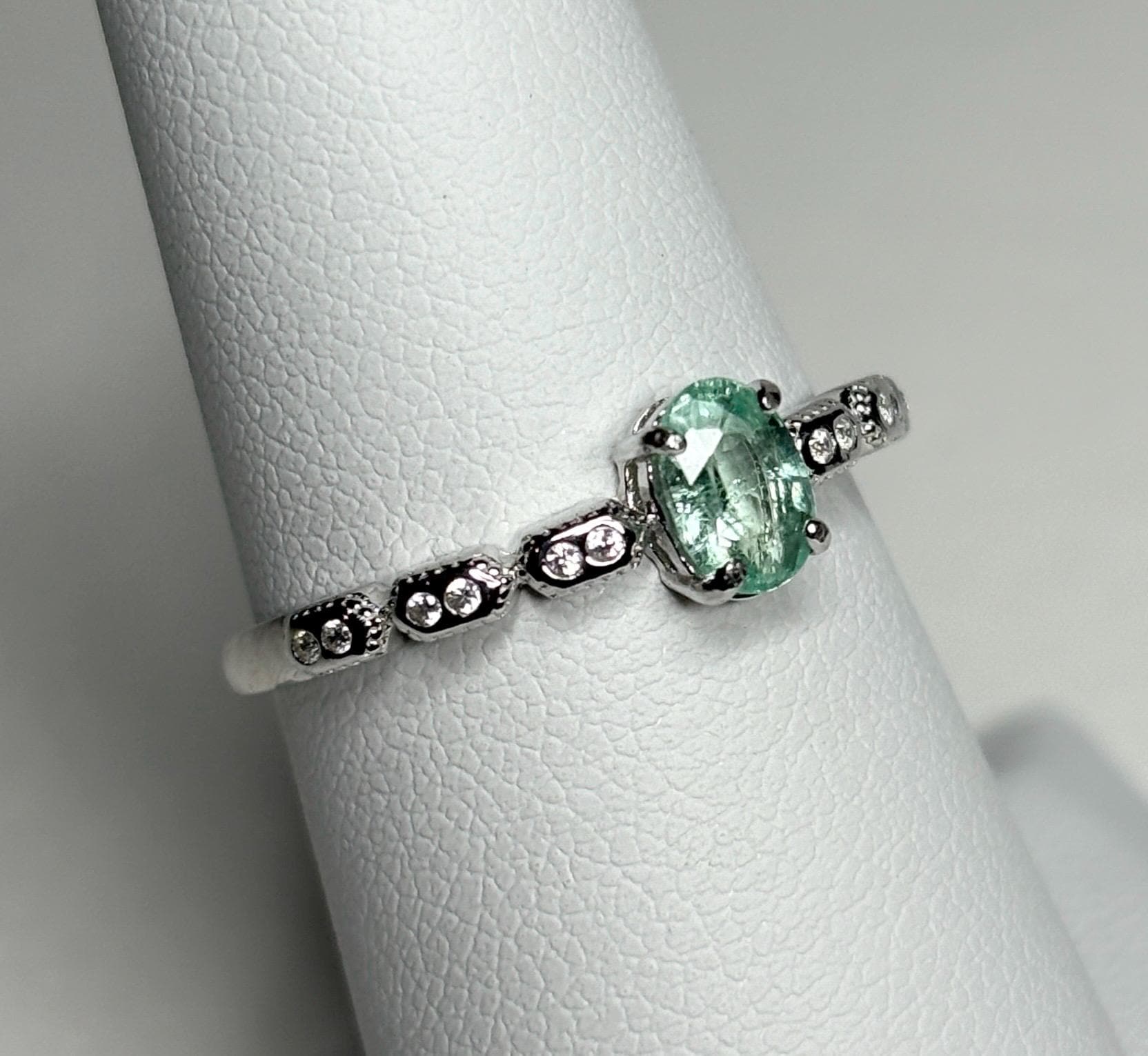 Sterling silver ring with an oval mint green tourmaline and small crystal accents.