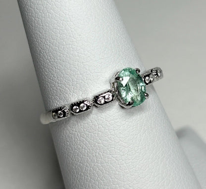 Sterling silver ring with an oval mint green tourmaline and small crystal accents.