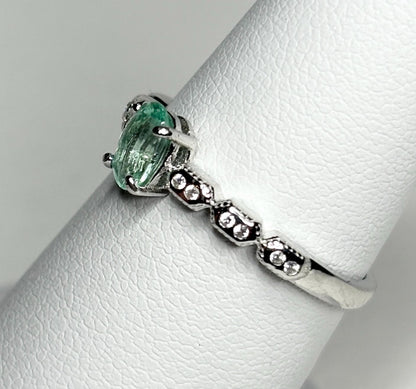 Sterling silver ring with an oval mint green tourmaline and small crystal accents.