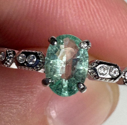 Sterling silver ring with an oval mint green tourmaline and crystal accents.