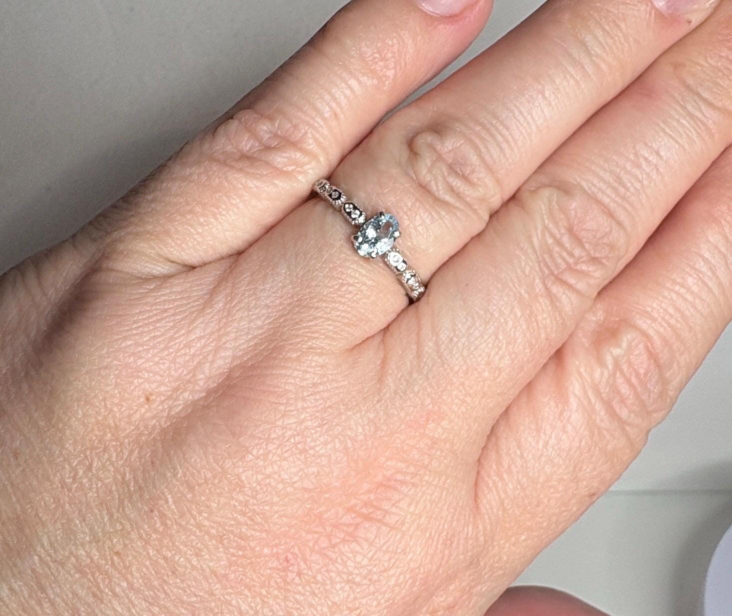 Sterling silver ring with an oval light blue tourmaline and crystal accents.