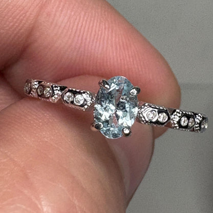 Sterling silver ring with oval light blue tourmaline and crystal accents.