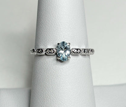 Sterling silver ring with an oval light blue tourmaline and crystal accents.