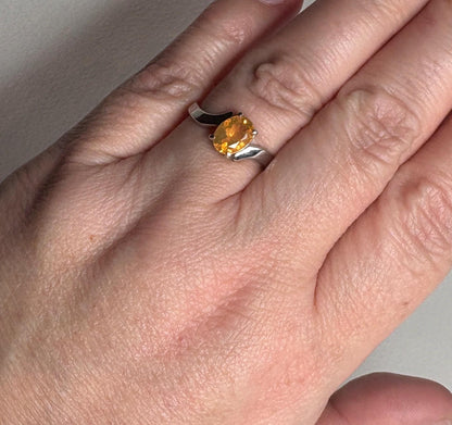 Sterling silver bypass ring with an oval Brazilian fire opal.